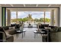 Spacious living room boasts comfortable seating and seamless indoor-outdoor flow to the pool area at 6215 N Casa Blanca Dr, Paradise Valley, AZ 85253