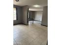 Open-concept living room with tile flooring, neutral paint, and a view into another room at 815 W Kiva Ave, Mesa, AZ 85210
