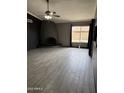 Living room with a modern fireplace, large window, and wood-look tile flooring at 815 W Kiva Ave, Mesa, AZ 85210