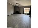 Spacious living room with tile flooring, fireplace, ceiling fan, and natural light from a window at 815 W Kiva Ave, Mesa, AZ 85210