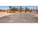 House exterior with gated entry and large paved driveway at 18654 W Solano Dr, Litchfield Park, AZ 85340