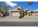 Charming two-story home featuring desert landscaping, a two-car garage, and a beige stucco exterior at 19406 N 31St Way, Phoenix, AZ 85050