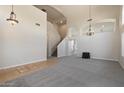 Spacious living room featuring high ceilings, neutral carpet, and an elegant chandelier at 19406 N 31St Way, Phoenix, AZ 85050