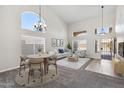 Bright living room with high ceilings, large windows, and elegant chandelier lighting at 19406 N 31St Way, Phoenix, AZ 85050