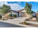 One-story home with tan exterior, two-car garage, and landscaping at 26722 N 174Th Ln, Surprise, AZ 85387