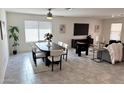 Open-concept living and dining area with modern decor, including a dining table and comfortable seating at 26722 N 174Th Ln, Surprise, AZ 85387