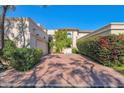 Luxury home exterior with a private driveway and lush landscaping at 6701 N Scottsdale Rd # 24, Scottsdale, AZ 85250
