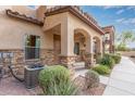 View of the home's exterior, showcasing stonework and landscaping at 2821 S Skyline Dr # 123, Mesa, AZ 85212