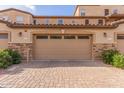 Two-car garage with paver driveway and landscaped surroundings at 2821 S Skyline Dr # 123, Mesa, AZ 85212
