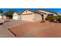 Tan house with a beige garage door and small front yard at 3150 W Foothill Dr, Phoenix, AZ 85027