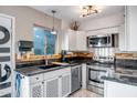 Bright kitchen featuring white cabinetry, granite countertops, and stainless steel appliances at 4600 N 68Th St # 313, Scottsdale, AZ 85251