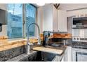 Close-up of stainless steel appliances, a black granite countertop and stylish faucet at 4600 N 68Th St # 313, Scottsdale, AZ 85251