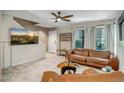 Spacious living room boasts neutral paint, tile floors, large windows, and leather furnishings at 4600 N 68Th St # 313, Scottsdale, AZ 85251