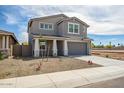 Charming two-story home with a large driveway and gravel landscaping with flower bed at 5534 W Banff Ln, Glendale, AZ 85306