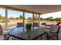 Covered patio with seating area and view of golf course at 10726 W Palmeras Dr, Sun City, AZ 85373