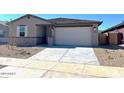 Charming single-story home featuring a two-car garage and low-maintenance front yard at 22489 W Pontiac Dr, Surprise, AZ 85387