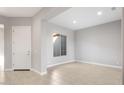 Bright, open-concept living room featuring neutral paint and tile floors; a bright and airy space at 24691 N 169Th Ave, Surprise, AZ 85387