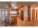 Spacious kitchen with wood cabinets, granite island, and stainless steel appliances at 2804 W Curry St, Chandler, AZ 85224