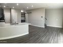 Open-concept living space featuring wood-style flooring, a kitchen island, and modern finishes at 1406 W Main St # 140, Mesa, AZ 85201