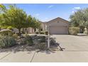 Well-maintained single-story home with desert landscaping, spacious driveway, and a charming facade at 14430 N Prickly Pear Ct, Fountain Hills, AZ 85268