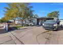 House with a driveway and a spacious front yard at 3206 W Garfield St, Phoenix, AZ 85009