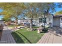 House with a large front yard, featuring a basketball hoop and a fountain at 3206 W Garfield St, Phoenix, AZ 85009