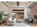 Bright and airy living room with a fireplace and access to a patio at 7624 E Stagecoach Pass, Carefree, AZ 85377