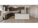Open kitchen boasts an island, granite countertops, and stainless steel appliances at 17867 W Encinas Ln, Goodyear, AZ 85338