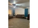 Spacious living room with tile floors, ceiling fan, and comfortable seating area at 15 W Mill Reef Dr, San Tan Valley, AZ 85143