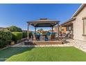 Spacious backyard with a gazebo and fire pit at 303 W Mammoth Cave Dr, San Tan Valley, AZ 85140