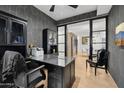 Stylish home office with a large desk, chair, and built-in shelving at 5250 E Deer Valley Dr # 153, Phoenix, AZ 85054