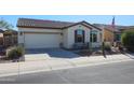 Single-story home with a two-car garage and desert landscaping at 17547 W Silver Fox Way, Goodyear, AZ 85338