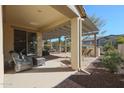 Spacious covered patio with comfortable seating at 17547 W Silver Fox Way, Goodyear, AZ 85338