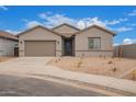 Charming single-story home with a two-car garage and low-maintenance desert landscaping at 31465 N Wet Creek Rd, San Tan Valley, AZ 85143
