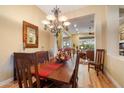Spacious dining room features hardwood floors, a large table, and a view into the living room at 41348 N Congressional Dr, Anthem, AZ 85086