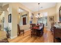 Bright dining room with hardwood floors, wood table, and chandelier at 41348 N Congressional Dr, Anthem, AZ 85086
