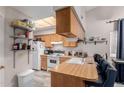 Kitchen boasts wood cabinets, white appliances, and a breakfast bar at 170 E Guadalupe Rd # 14, Gilbert, AZ 85234