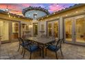 Outdoor patio with dining area and string lights at 501 E Sunburst Ln, Tempe, AZ 85284