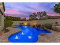 Relaxing freeform pool with blue lighting at 501 E Sunburst Ln, Tempe, AZ 85284