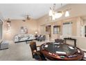 Spacious living room with plush seating, stylish decor, and a game table for entertaining at 19814 N Shadow Mountain Dr, Surprise, AZ 85374