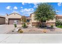 Inviting single-story home with a two-car garage, desert landscaping, and stone accents at 26822 W Oraibi Dr, Buckeye, AZ 85396