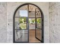 Arched front door with black frame and glass panes at 4424 N 38Th St, Phoenix, AZ 85018