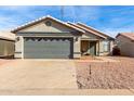 Single-story house with gray garage door and rock landscaping at 8813 N 112Th Ave, Peoria, AZ 85345