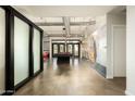 Large game room with a sleek pool table, concrete floors, and access to the outdoors at 914 E Osborn Rd # 202, Phoenix, AZ 85014