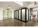 Modern game room featuring unique decor, concrete floors, and bar area at 914 E Osborn Rd # 202, Phoenix, AZ 85014