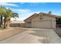 Exterior view featuring desert landscaping, tiled roof, and two car garage at 10309 E Twilight Ct, Sun Lakes, AZ 85248