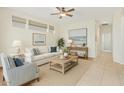 Inviting living room boasting neutral tones, tile floors, a cozy sofa, and bright natural light at 9354 E Hillview Cir, Mesa, AZ 85207