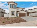 Charming two-story home featuring a terracotta roof, stucco siding, blue shutters, and a spacious three-car garage at 4924 W Beryl Ave, Glendale, AZ 85302