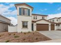 Charming two-story home featuring a terracotta roof, stucco siding, blue shutters, and a spacious three-car garage at 4924 W Beryl Ave, Glendale, AZ 85302