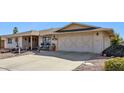 Front view of a ranch-style house with a two-car garage at 9427 W Garnette Dr, Sun City, AZ 85373